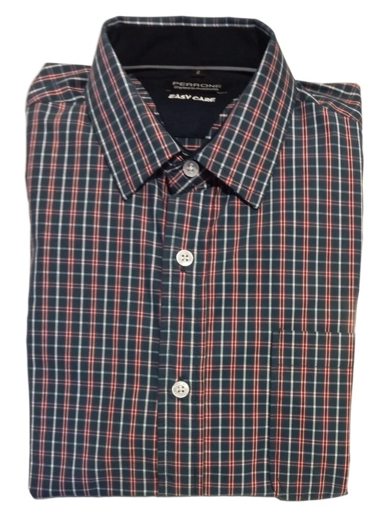 Folded plaid shirt on a white surface with a blurred background