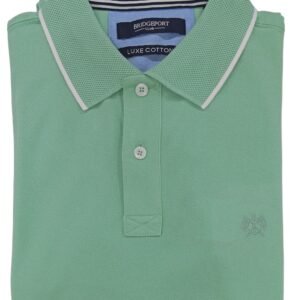 Folded green polo shirt on a light gray background