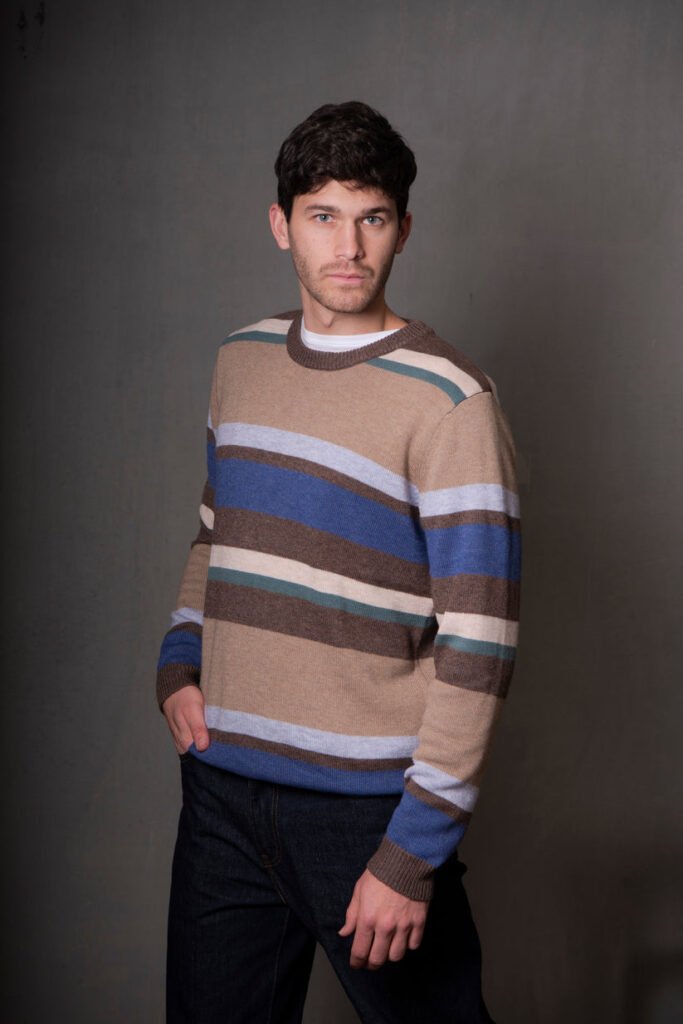 Man wearing a striped sweater against a plain background