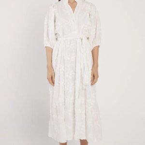 Woman wearing a white dress on a plain background