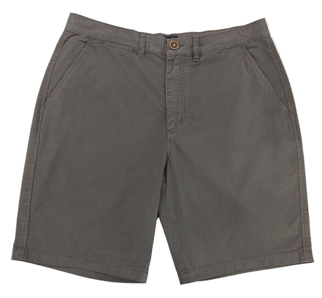 Gray shorts on a white surface with a textured gray background
