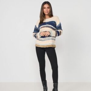 Woman wearing a striped sweater and black leggings on a white background