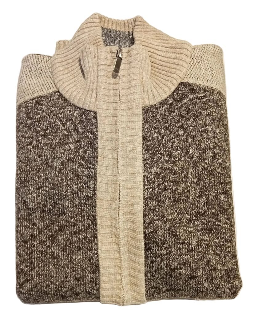 Folded sweater with a color block design on a white surface.