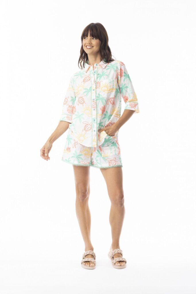 Woman wearing a floral pajama set on a white background