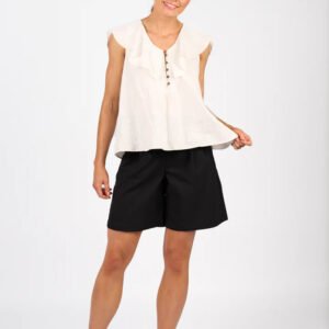 Woman wearing a white sleeveless top and black shorts on a white background
