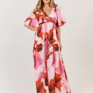 Woman wearing a floral dress with pink and orange flowers on a white background